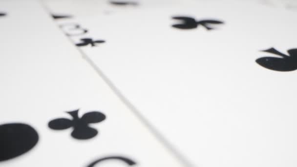 Extremely close-up detailed shot of playing cards suits of spades and clubs lying randomly on the table — Stock videók