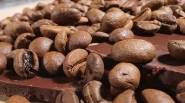 Extreme close-up of detailed coffee beans and bittersweet chocolate chunks with whole hazelnuts