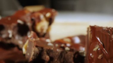 extreme close-up detailed broken pieces of bittersweet chocolate with whole hazelnuts