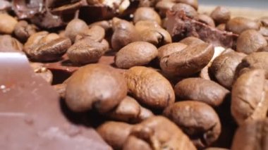 Extreme close-up of detailed coffee beans and bittersweet chocolate chunks with whole hazelnuts