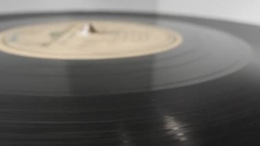 extreme close-up, detailed. Old phonograph needle on a spinning vinyl record