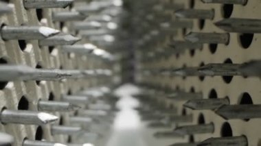 extremely close-up detailed plan of sharp nails. view between two sadhu boards.