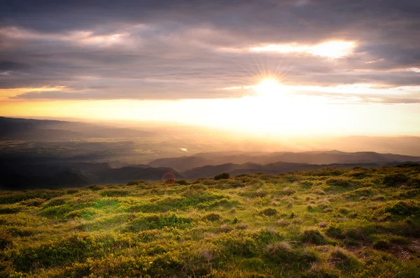 Puesta de sol sobre el pequeño pico de la montaña . —  Fotos de Stock