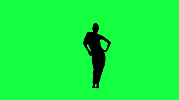 The silhouette of a dancing woman against a green background — Stock Video