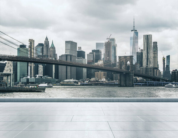 Empty concrete quay on the background of a beautiful Manhattan city skyline and Brooklyn bridge at sunset, mock up
