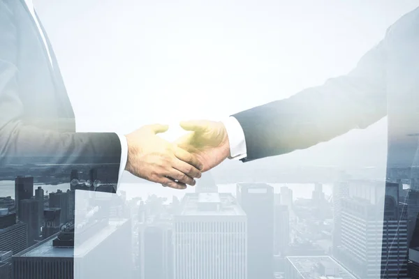 近代的な都市スカイラインの背景に2人のビジネスマンの握手、契約とパートナーシップの概念。多重露光 — ストック写真