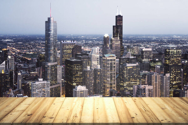 Table top made of wooden dies with Chicago city view at dusk on background, template
