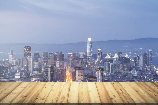 Wooden table top with beautiful San Francisco skyline at night on background, mockup