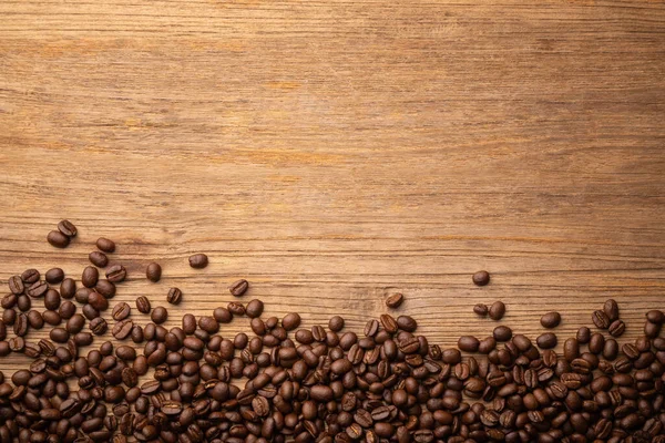 Close up coffee bean on wooden table background. Food and beverage concept