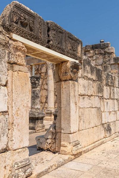 Capernaum, Israel May 18, 2022 Reconstruction of the ruins of the White Synagogue. Translation. "Herod, the son of Monimos, and Justus, his son, together with their children erected this column."
