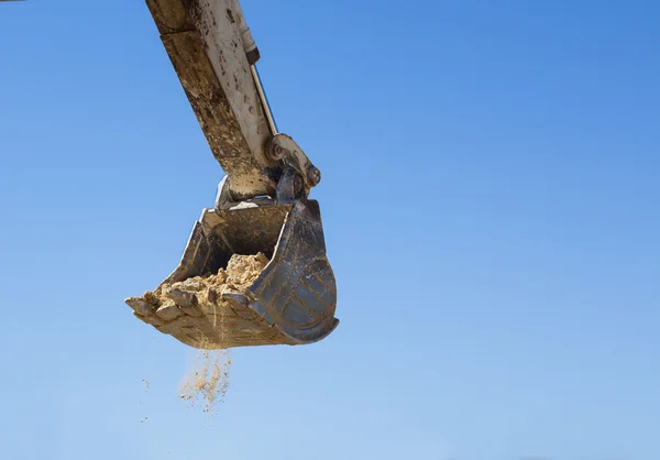 Graafmachine in exploitatie Rechtenvrije Stockafbeeldingen