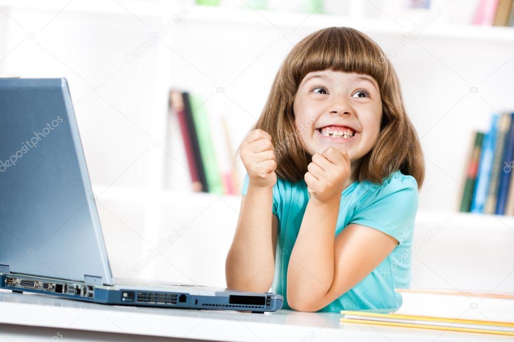 Excited little girl with laptop