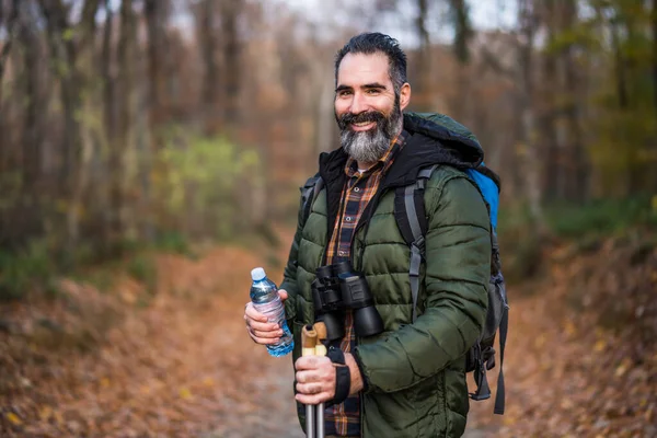 stock image Image of man holding bottle  of water while hiking.