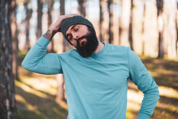 stock image Man with beard enjoys exercising in nature.