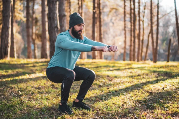 Man with beard enjoys exercising in nature.