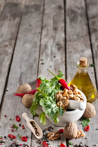 Cilantro and walnuts in a mortar — Stock Photo, Image