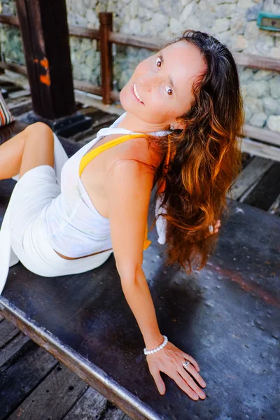 Attractive woman sitting on a swing — Stock Photo, Image