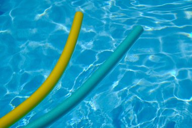 Sarı ve mavi erişte yüzme havuzunda. mavi su.