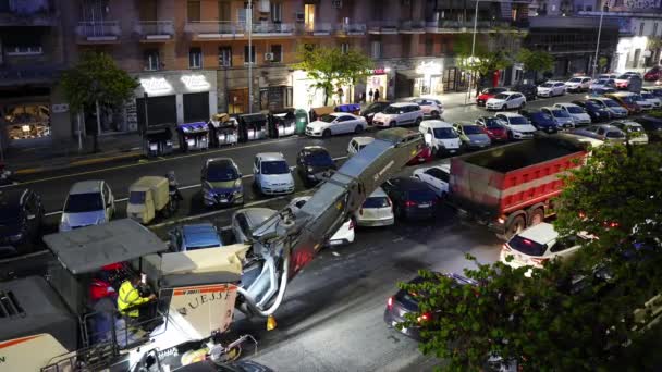 ROME, ITALY - APRIL 9, 2021: Heavy grader truck driving along the street with parking lots in residential area of Rome, removing with pressure old ruined asphalt and throwing inside the passing truck — Stock Video