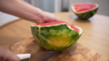 Cutting ripe red watermelon on pieces with kitchen knife, juicy summer fruit rich of vitamins being good for human body. Preparing watermelon on pieces for eating, healthy lifestyle. High quality 4k