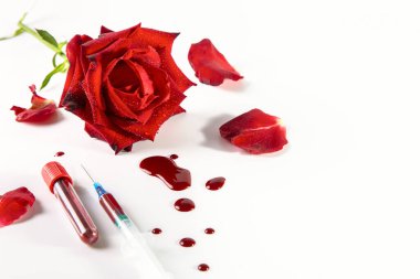 Red rose, drops of blood, syringe and test tube with blood on a white background. clipart