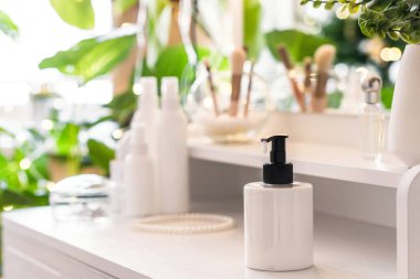 Günlük kadın kremi makyaj malzemeleriyle tuvalet masasında. Noel ağacının yansıması, masa aynasında ampuller..