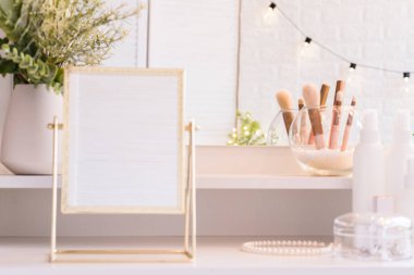 Noel ağacının yansıması, ampuller, makyaj malzemeleriyle makyaj masasındaki kadın aynası.