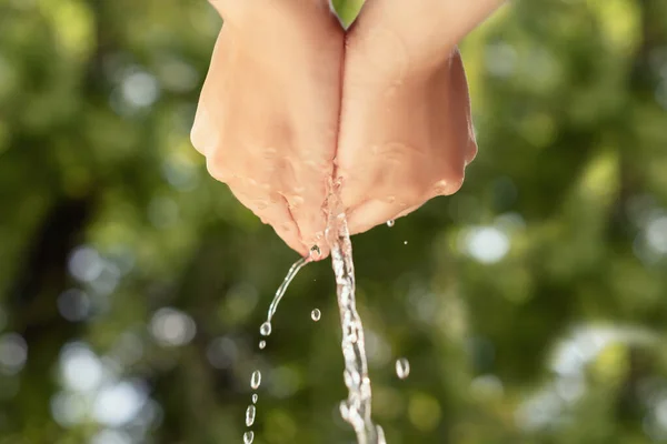 Water Drops Pouring Female Hands Green Background Organic Nature Concept — стоковое фото