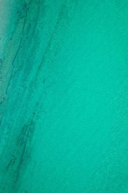 Background, texture of relaxing, calm turquoise, transparent sea water with stones, slabs, lump, coral. Summer vacation. Blue ocean lagoon. Drone, copter top view. 