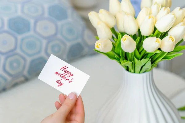 테이블 꽃병에 꽃다발에서 어머니 카드를 꺼내는 — 스톡 사진
