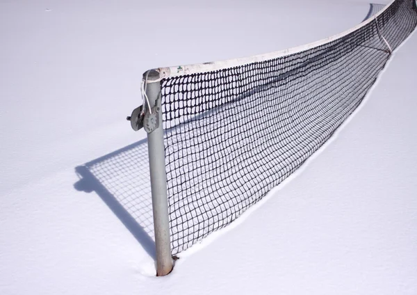 Tennis net at wintertime with snow and shadow — Stok fotoğraf