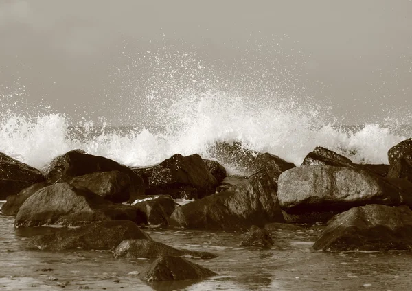 Stille water achter grote stenen op strand — Stockfoto