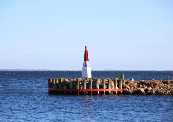 Marker on mole at entrance to small port — Stock Photo, Image