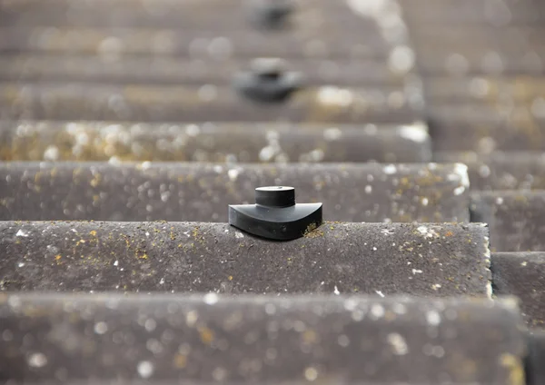 Screw protection stud on asbestos roof — Stock Photo, Image