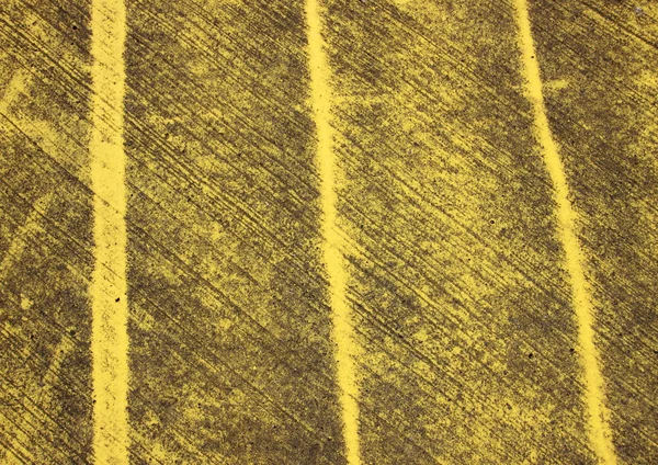 Pattern with yellow stripes painted on asphalt — Stock Photo, Image