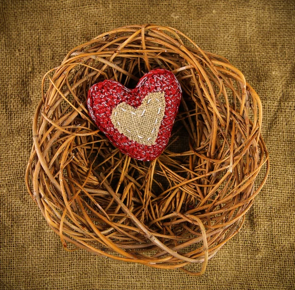 One handmade heart in the nest — Stock Photo, Image