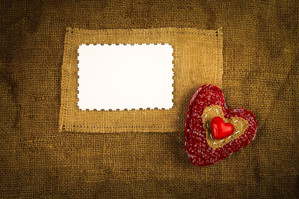 Knitting heart on the sackcloth — Stock Photo, Image