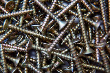 Üçlü vidalar, bir sürü. Yakın plan. Geçmişi ve dokuları. Ahşap üzerine inşaat malzemeleri. Fastener. Üst görünüm.