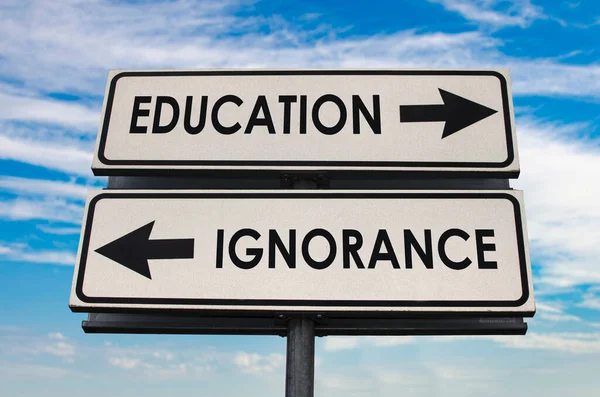 Education Ignorance Road Sign Two Arrows Blue Grey Sky Background — Fotografie, imagine de stoc