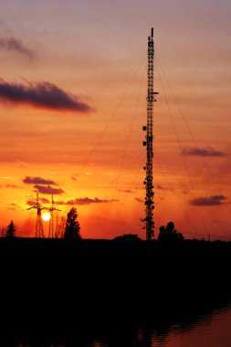 Cell tower on the sunset sky