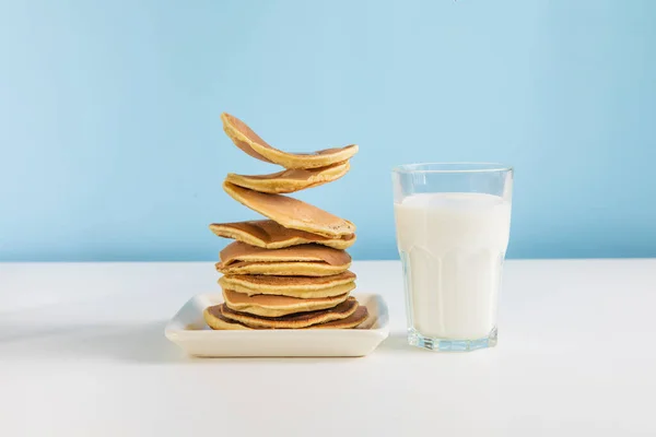 Levitating Stack Pancakes Honey Glass Milk Blue Background Levitation Gravity — Zdjęcie stockowe