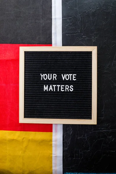 Letterboard Sign Words Your Vote Matters German Flag Black Background — Zdjęcie stockowe