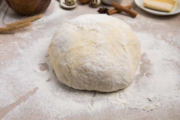 Beat flour and kitchen utensils, a baking dish, a rolling pin with eggs on the table. Baking, cooking concept. Chef making bread and gingerbread cookies. The cook kneads and rolls the dough.