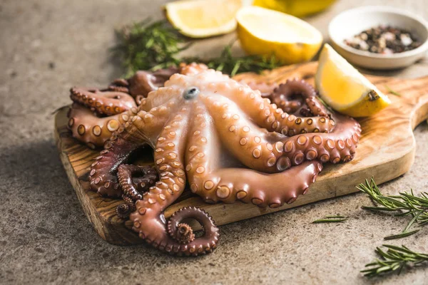 Octopus cooked with chopped herbs served on a  board