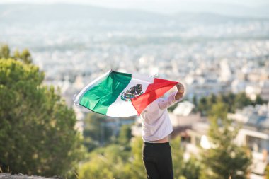 People holding flag of Mexico. 