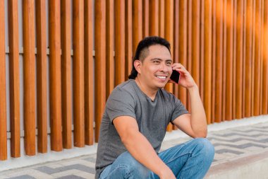 Young Indigenous Man Using Mobile Phone Outdoors