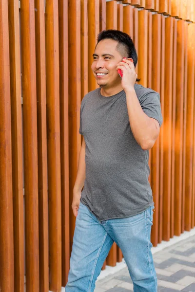 Young Indigenous Man Walking Street While Talking Cell Phone — Foto Stock