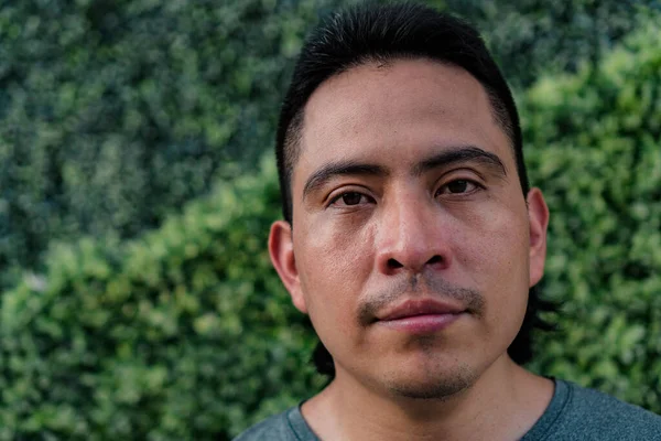 Close up portrait of young Aboriginal Colombian man outdoors
