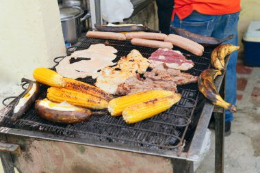 A close-up of a grill with different foods on a barbecue.