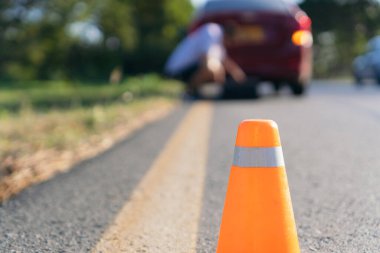 Emergency stop sign and man with broken down car on the highway
